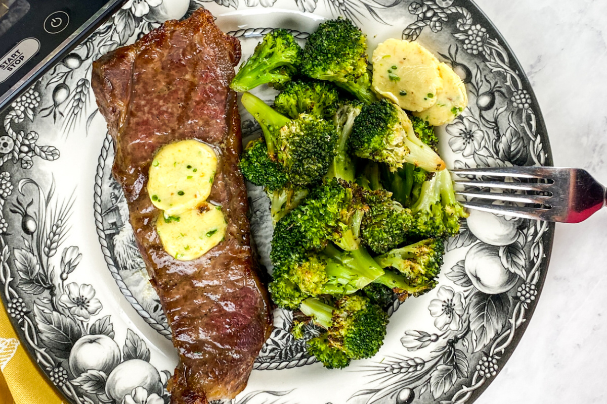 Roasted Garlic Compound Butter on strip steak and broccoli