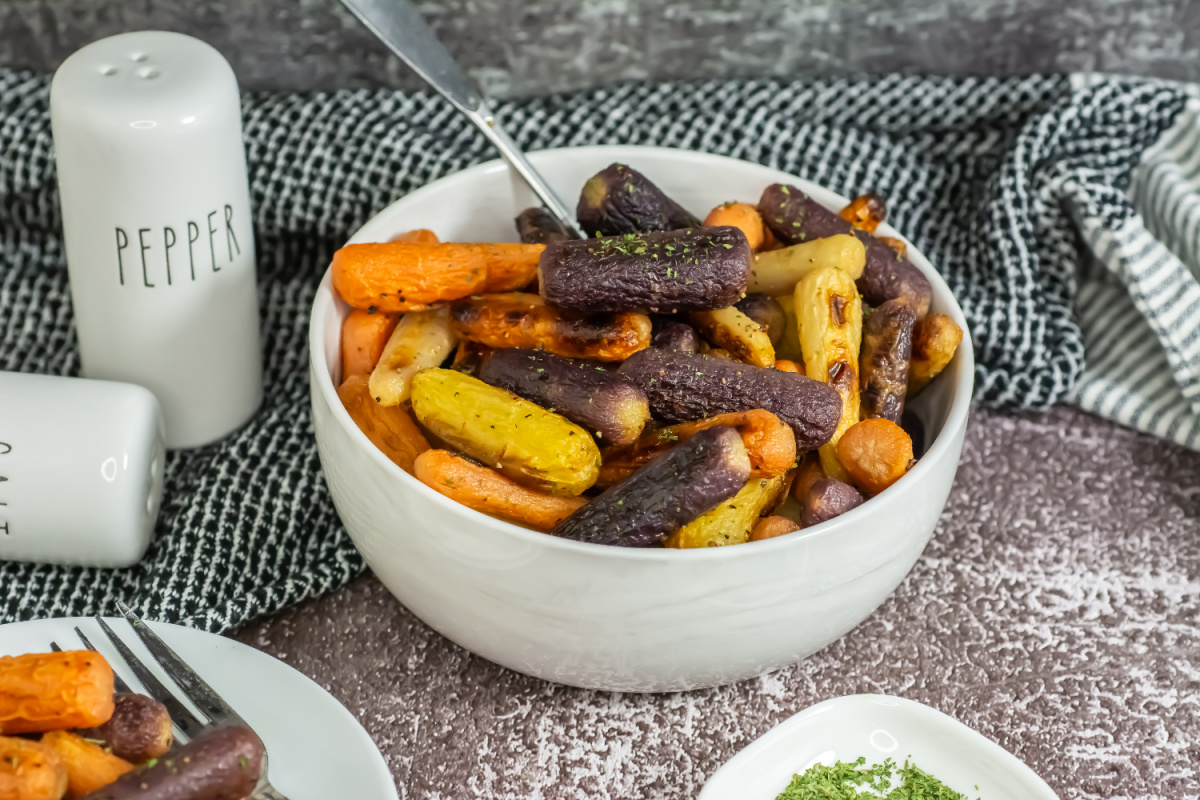 Multi colored roasted carrots in a serving bowl