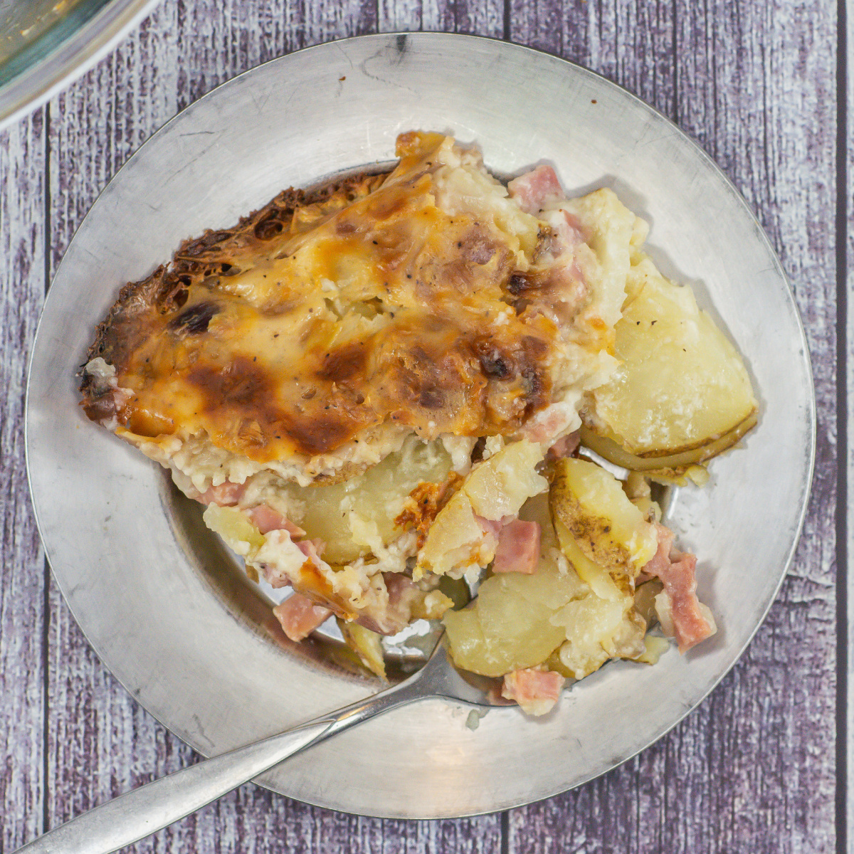 Scalloped potatoes with ham on a small plate